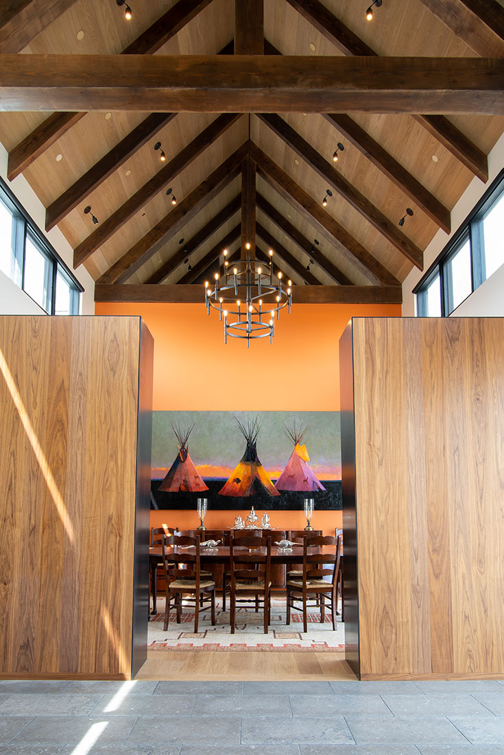 A dining room space is flanked by the finely crafted cabinetry that is the specialty of Willow Creek Woodworks, with accents in metal that are selected with the design sense of the clientele in mind.