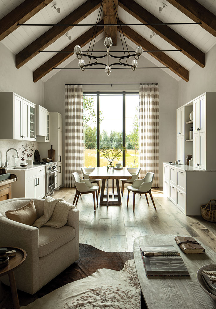 The culinary alcove adjoining the living space is able to do double duty (as kitchen and dining area) thanks to the live-edge walnut table custom made locally. Brazilian chairs accompany the sculptural table.