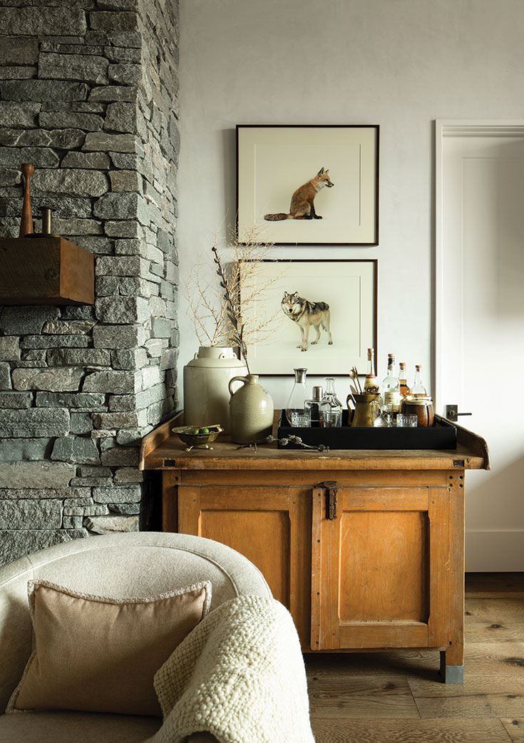 The antique pine cabinet, set up as a bar, epitomizes the priority applied throughout the cabin of incorporating storage whenever— subtly, sophisticatedly—possible.